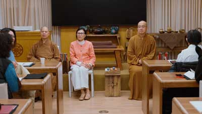 Classroom with Monks in Brown Robes and Dr. Ta