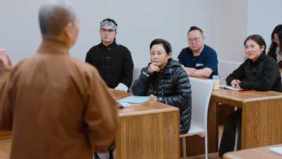 Classroom of Students and lecturer in brown robe